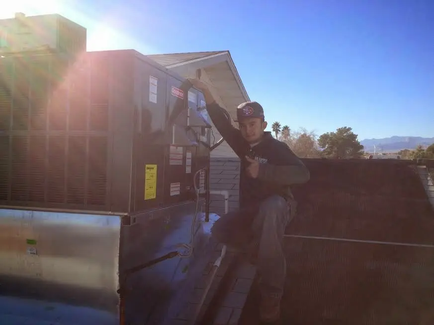 HVAC technician performing Boiler Repair on a rooftop unit in Taneytown
